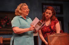 Margaret (Gayle Grimes) examining a religious pamphlet given to her by the Evangelical Melissa (Lori Brooks). Phot courtesy of Reston Community Players.