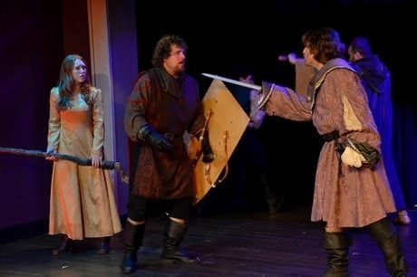 The Red Knight (Nick Hagy center) finds himself in a strongly disadvantaged situation at the end of the sword of King Richard (Kyle McGruther). The king's ward, Minda (Jordan Slattery) looks on in 'Medieval Story Land.' Photo by Chelsie Lloyd.