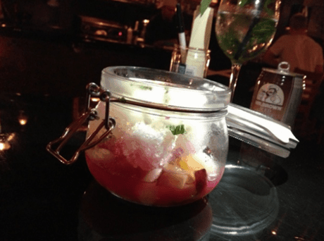 Shaved ice with sweetened condensed milk, fresh peaches and mochi served in a Mason jar.