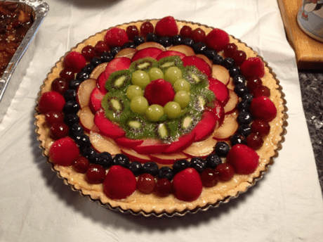  12 ½ inch tart with strawberries, red and green grapes, blueberries, black and red plums and kiwi fruit.
