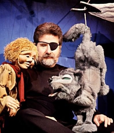 Christopher Piper (Center) and Peter and the Wolf. Phot ocourtesy of The Puppet Co.
