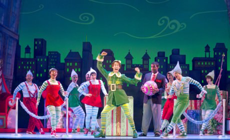 Buddy the Elf (Matt Kopec) performing "Sparklejollytinklejingley" with the elves and Store Manager (Clyde Voce) of Macy's. Photo by Joan Marcus.