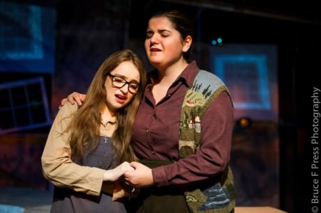 Hailey Ibberson (Carrie White) seeks comfort from her mother (Tori Stroud) in Carrie: The Musical by the Teen Professionals troupe at the Drama Learning Center. Photo courtesy of Bruce F. Press Photography.