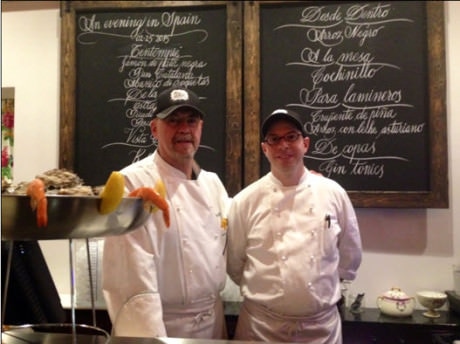 At the raw bar with Executive Chef Josu Zubikarai (left) and oyster shucker.