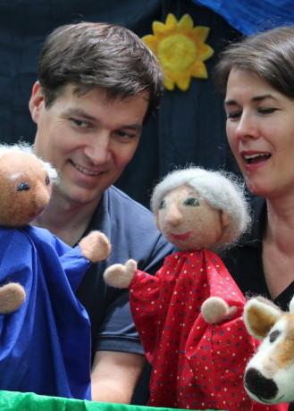 Ingrid Cowan Hass and Ole Hass with puppets.