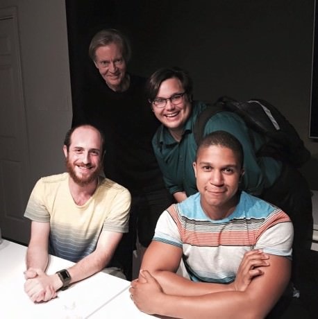 At 'Love Godfrey/Love George': Front Row: Joshua Simon (George) (left), and Jaysen Wright (right). Back Row: (L to R): Playwright John Stoltenberg and Director Michael Poandl (leaning in). Photo by Joey Hamilton.