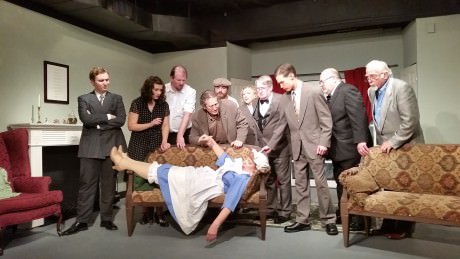 The cast gathers around Mrs. Rogers who fainted after the accusation. From left to right - Anthony Marston (William Stiles), Vera Claythorne (Emma Jensen), William Henry Blore (Chris Carothers), Dr. Armstrong (Dave Chalmers), Fred Narracott (Rocky Nunzio), Miss Emily Brent (Phyllis Kay), Sir Lawrence Wargrave (Larry Simmons), Captain Lombard (Kyle Kelley), Rogers (Jim Berard), General Mackenzie (Ron Able), and Mrs. Rogers (Ilene Chalmers) on the couch. Photo by Richard Atha-Nicholls.