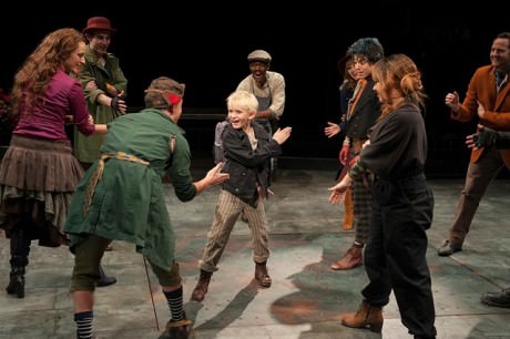 Jake Heston Miller (Oliver) and the company of Oliver! Photo by Margot Schulman.