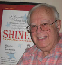Richard Seff in front of a poster of his Horatio Alger musical 'SHINE.' Photo by Joel Markowitz.