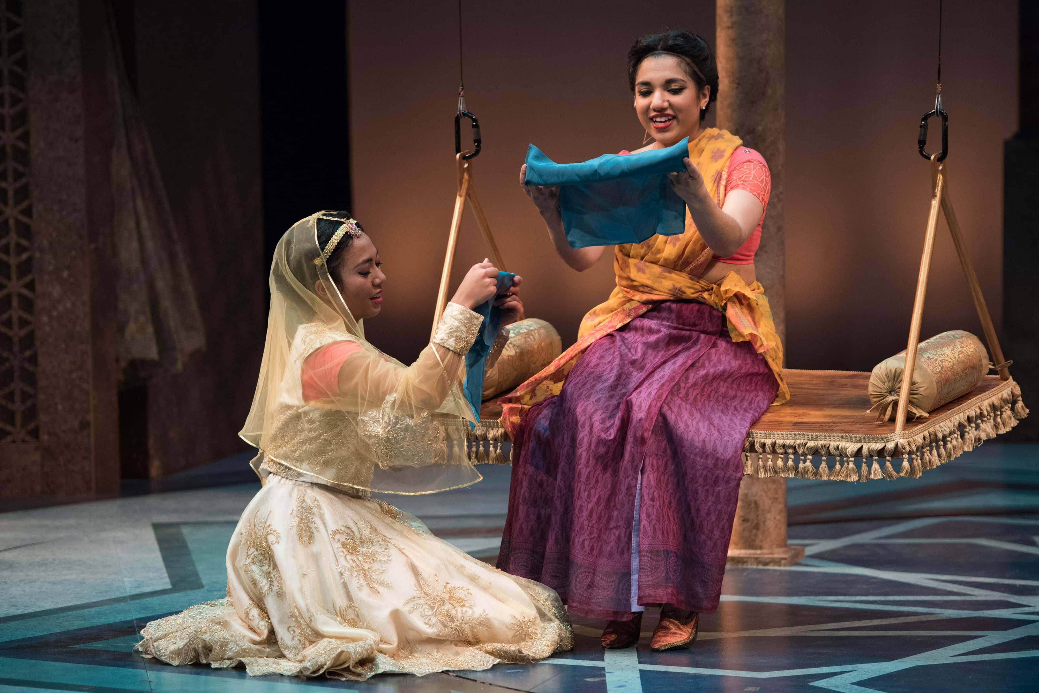Having switched clothes, Princess Razia and Rani exchange scarves. (L-R: Alexandra Palting, Anjna Swaminathan). Photo by Margot Schulman. 