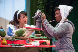 The Dormouse (Mabelle Fomundam) tells a story to Alice (Alexandra Palting). Photo by C. Stanley Photography