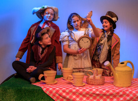 Clockwise from left: Marianne Meade as the Doormouse, Libby Brooke as the March Hare, Madeline Aldana as Alice, and Aashna Kapur as the Mad Hatter. Photo by Keith Waters Kx Photography.