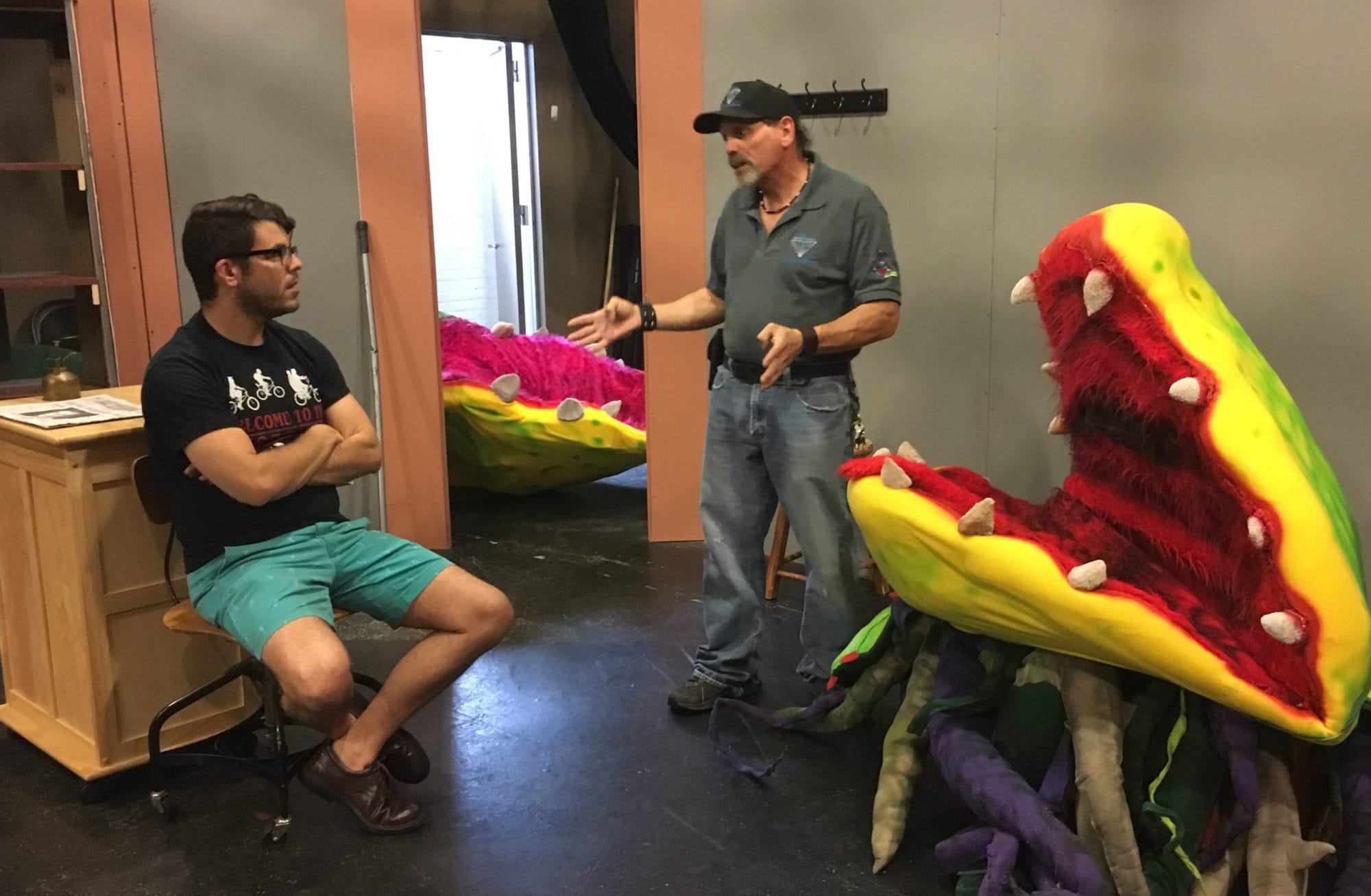 Casey Fero (playing Seymour), Bill Diamond (puppet designer, fabricator and instructor), and Audrey II (puppet) in rehearsal for 'Little Shop of Horrors' at Workhouse Arts Center. Photo courtesy of Workhouse Arts Center.