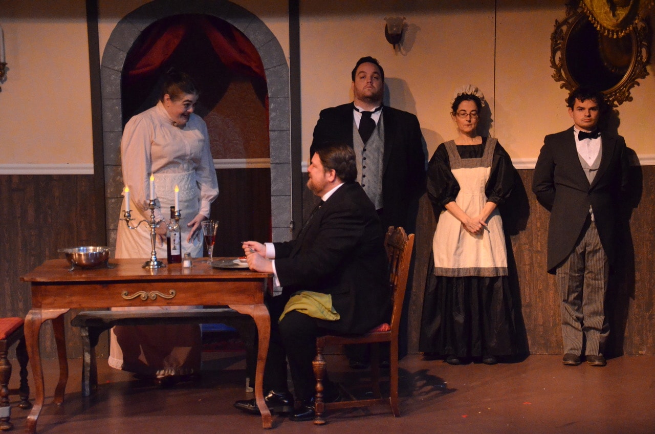 Viscount St. Galen (Jim Adams) compliments Myrna Fielding (Pamela Northrup) on her first meal cooked at his manor as Mr. Henderson (Michael Iacone), a maid (Jeannette Connors) and a footman (Tyler Dos Santos) stand by. Photo by Kris Northrup.